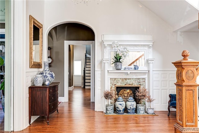 2002 Princess Anne Ave, Richmond, VA 23223 - living room with wood finished floors, vaulted ceiling, arched walkways, and a fireplace