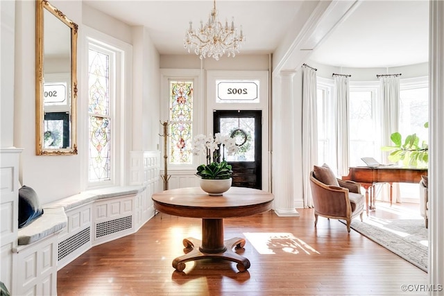 sitting room featuring wood-type flooring and a chandelier