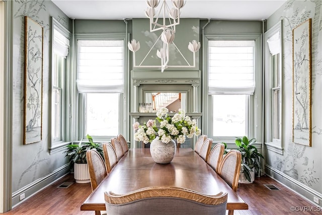 dining space featuring plenty of natural light, a chandelier, and wood-type flooring