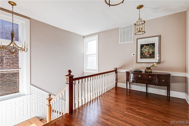 interior space featuring dark hardwood / wood-style flooring and a notable chandelier