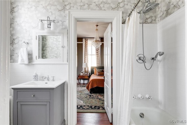 bathroom featuring hardwood / wood-style flooring, shower / tub combo with curtain, and vanity