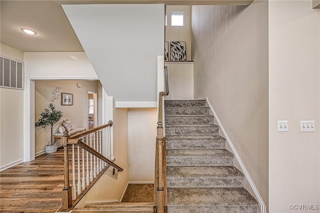 staircase featuring hardwood / wood-style floors