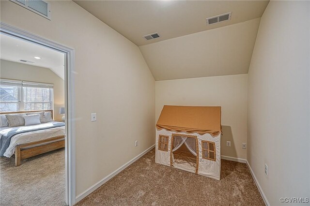 carpeted office featuring lofted ceiling