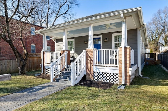 bungalow with a front yard and covered porch