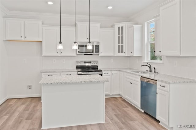 kitchen featuring white cabinetry, a center island, and stainless steel appliances