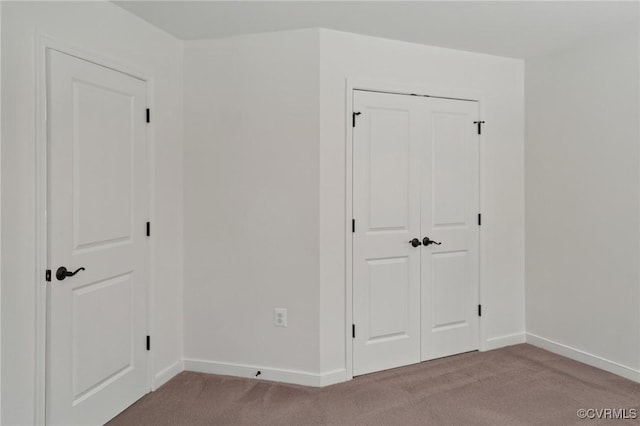 interior space featuring light carpet and a closet