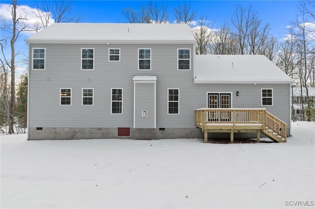 snow covered house with a deck