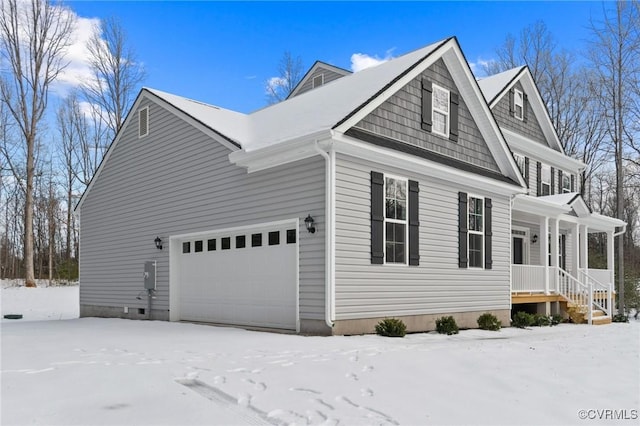 view of snow covered exterior with a garage