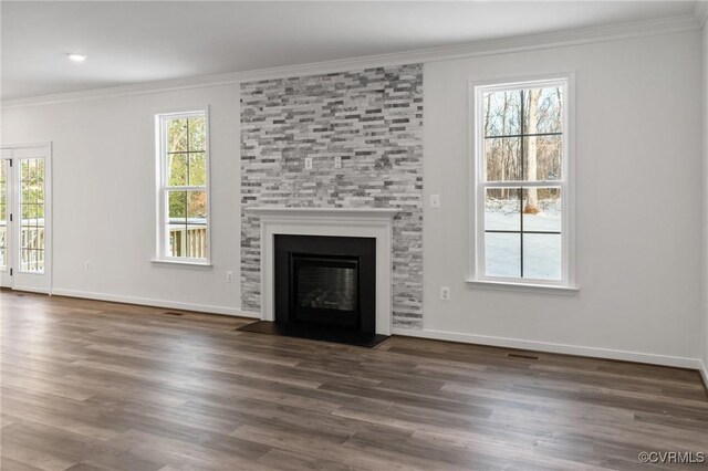 unfurnished living room featuring crown molding, dark hardwood / wood-style flooring, and a fireplace