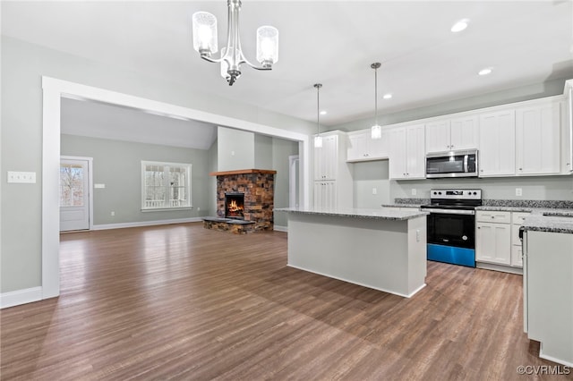 kitchen featuring pendant lighting, white cabinets, and appliances with stainless steel finishes