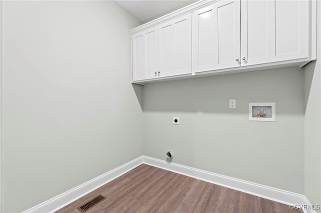 washroom featuring hardwood / wood-style flooring, hookup for a washing machine, cabinets, and hookup for an electric dryer