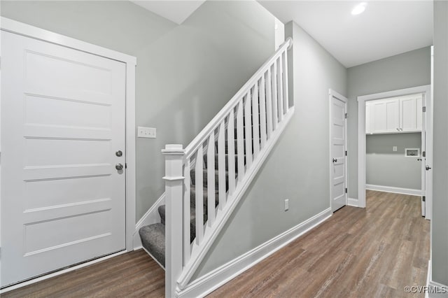 stairs featuring wood-type flooring