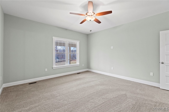 spare room with carpet and ceiling fan