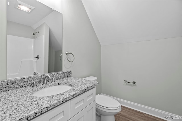 bathroom with a shower, wood-type flooring, vaulted ceiling, toilet, and vanity