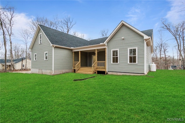 rear view of property with a yard