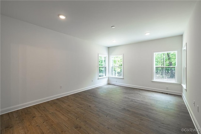 unfurnished room with dark hardwood / wood-style flooring