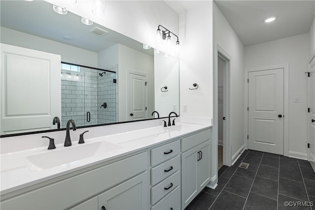 bathroom with tile patterned floors, vanity, and walk in shower