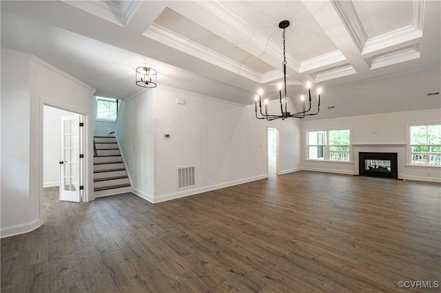 unfurnished living room featuring beam ceiling, crown molding, dark hardwood / wood-style flooring, and a notable chandelier