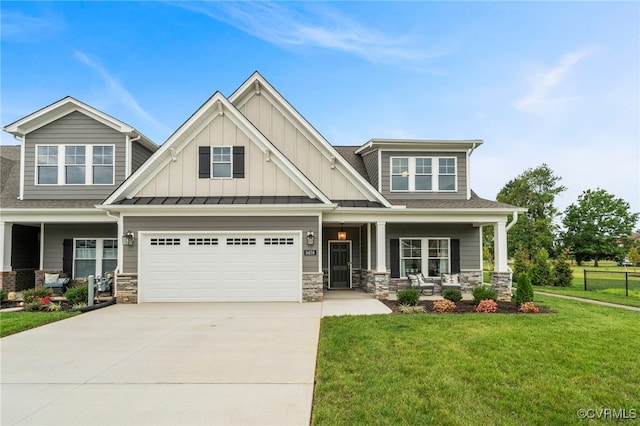 craftsman-style home featuring a front yard, a garage, and covered porch