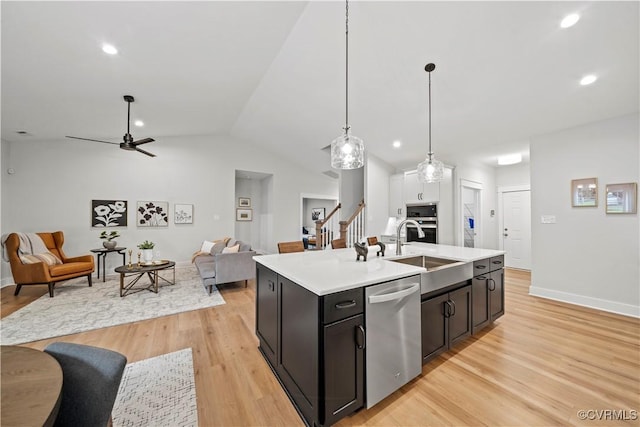 kitchen featuring ceiling fan, sink, pendant lighting, a kitchen island with sink, and appliances with stainless steel finishes