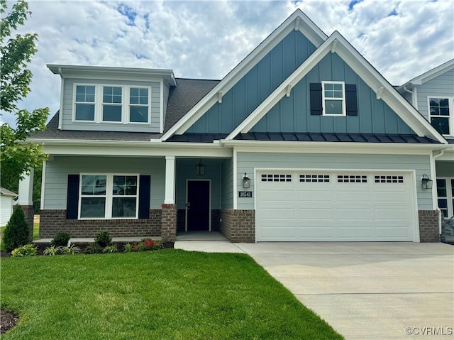 craftsman-style house featuring brick siding, concrete driveway, board and batten siding, a front lawn, and a garage