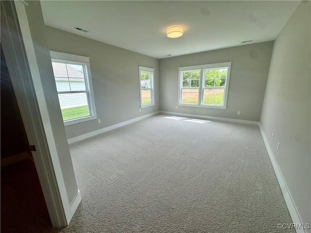 spare room with baseboards and carpet