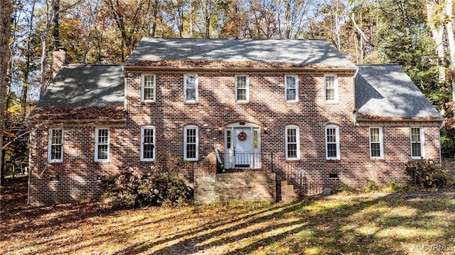 colonial inspired home with a front yard