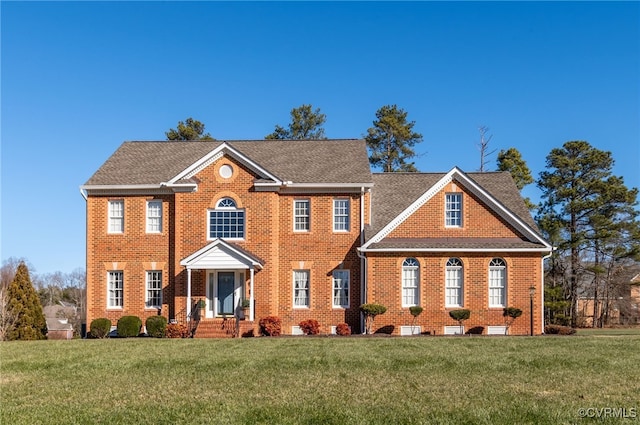 colonial-style house featuring a front lawn