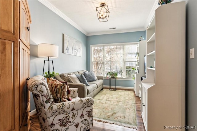 sitting room featuring light hardwood / wood-style flooring, an inviting chandelier, and ornamental molding