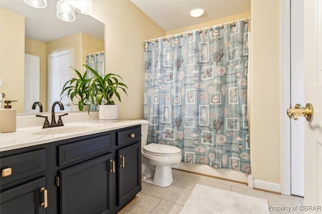 bathroom with tile patterned floors, vanity, and toilet