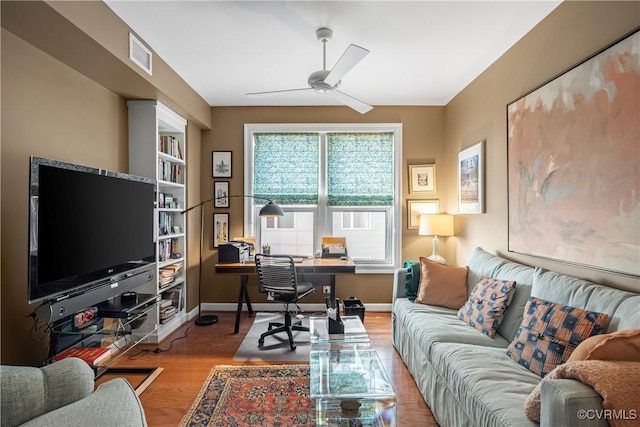 home office featuring light hardwood / wood-style floors and ceiling fan