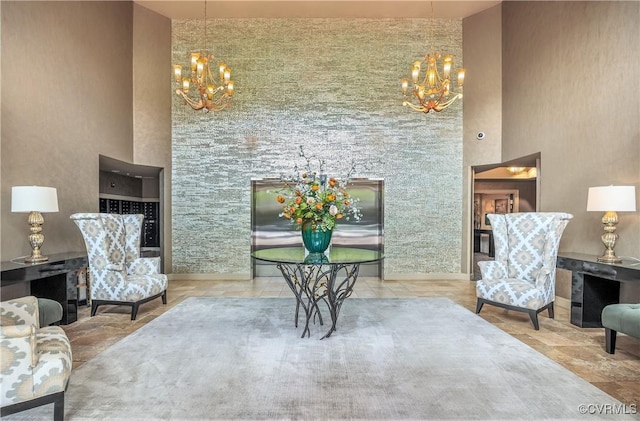 sitting room with a chandelier and a high ceiling