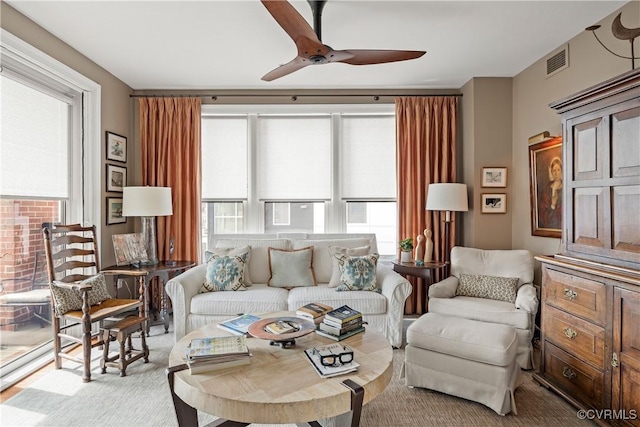 living room with a wealth of natural light and ceiling fan