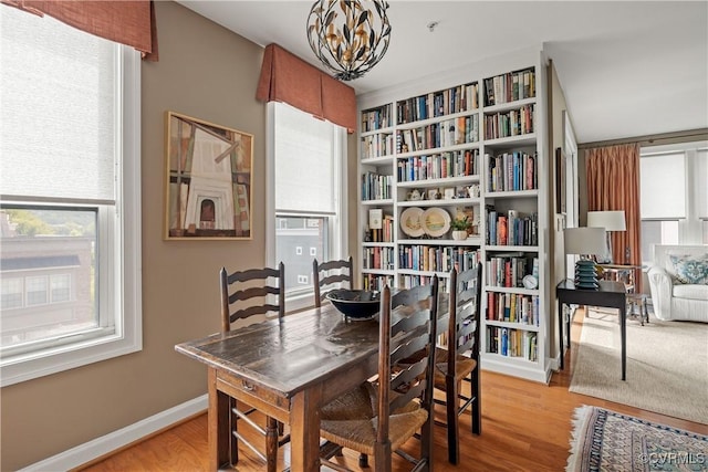 dining area with an inviting chandelier and light wood-type flooring