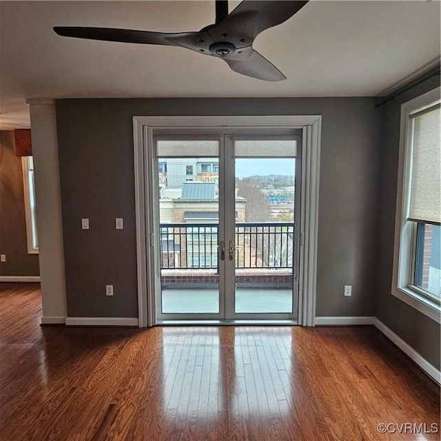 empty room with hardwood / wood-style flooring and ceiling fan