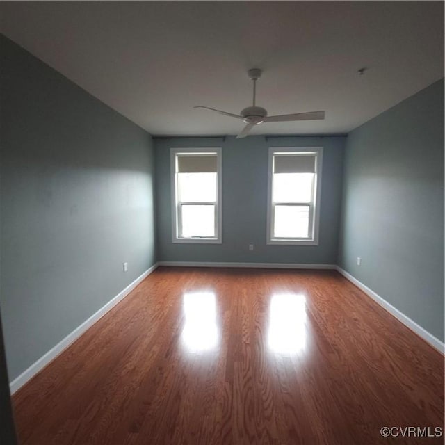 empty room with wood-type flooring and ceiling fan