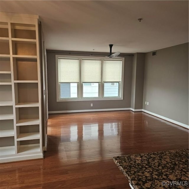 unfurnished living room with ceiling fan and hardwood / wood-style floors