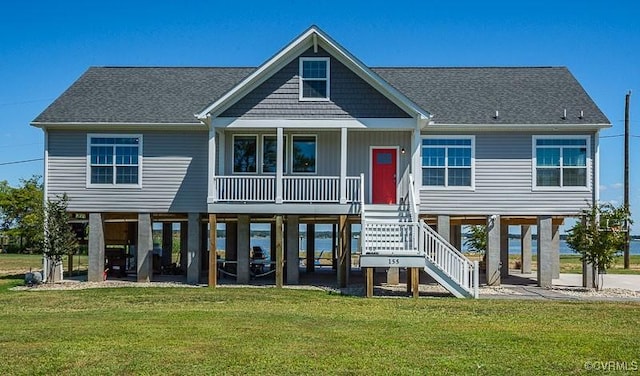 rear view of house featuring a yard, a porch, and a carport