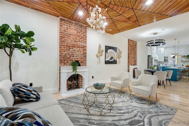 living room with light hardwood / wood-style floors, a notable chandelier, and wood ceiling