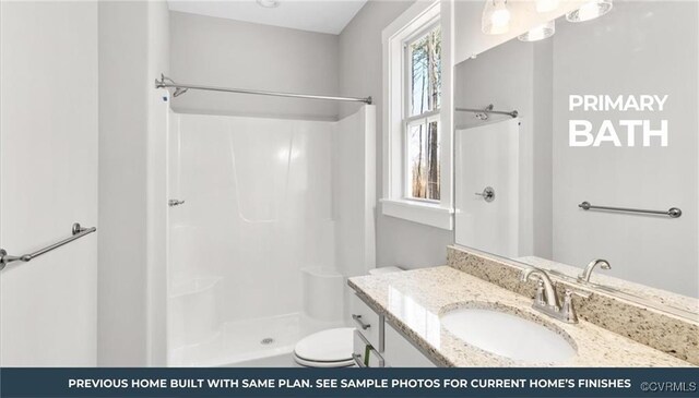 bathroom featuring walk in shower, vanity, toilet, and a wealth of natural light