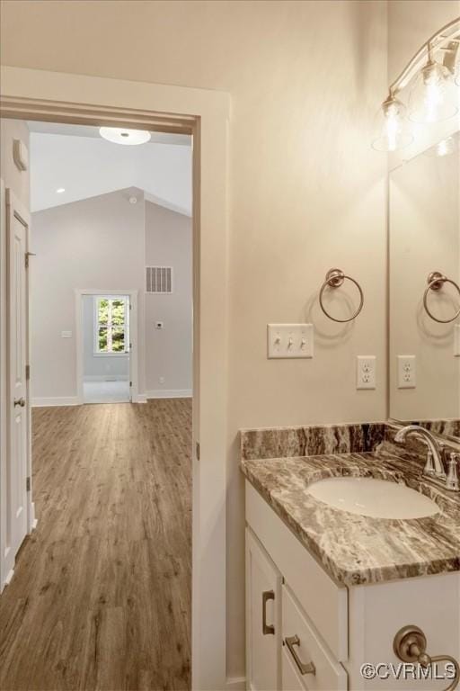548 Anchor Dr, Bracey, VA 23919 - bathroom with vanity, wood finished floors, and vaulted ceiling