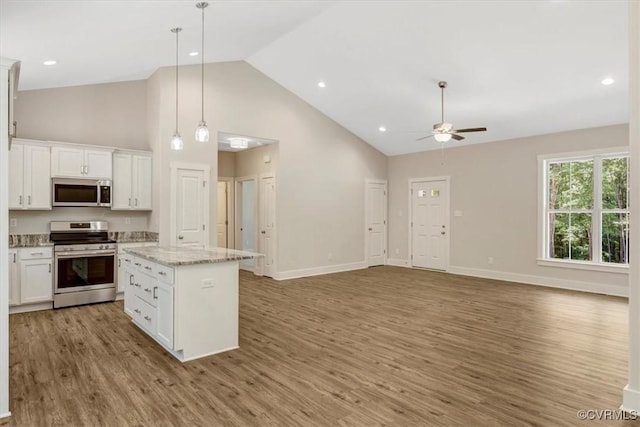 548 Anchor Dr, Bracey, VA 23919 - kitchen with stainless steel appliances, ceiling fan, high vaulted ceiling, light wood-style flooring, and white cabinets