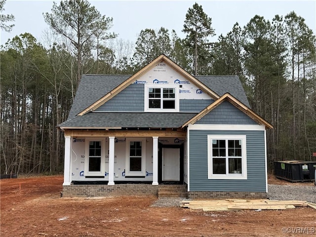 view of front of home with a porch and cooling unit