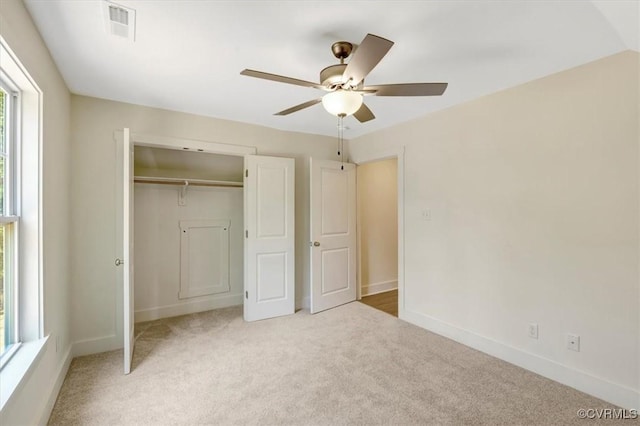 73 Jamestown Ln, Bracey, VA 23919 - unfurnished bedroom with light colored carpet, a closet, and a ceiling fan