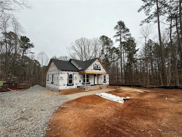 property in mid-construction with covered porch