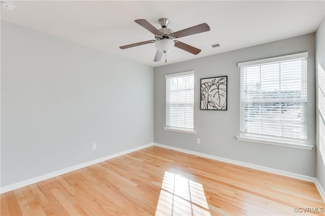 spare room with hardwood / wood-style flooring and ceiling fan