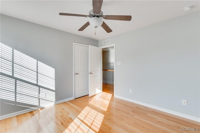 spare room with hardwood / wood-style floors and ceiling fan