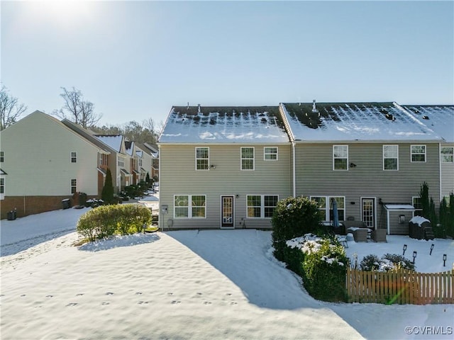 view of snow covered rear of property