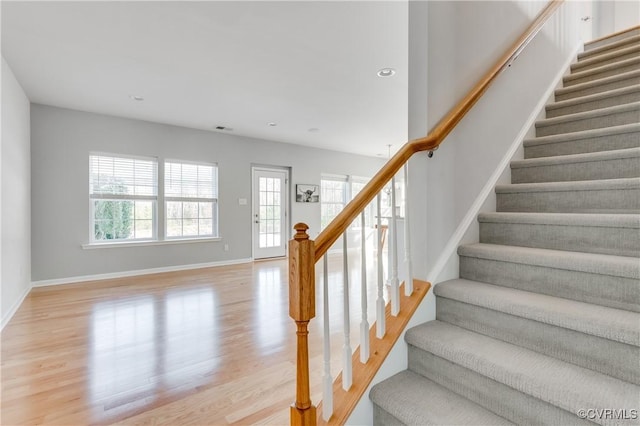 stairway with hardwood / wood-style floors