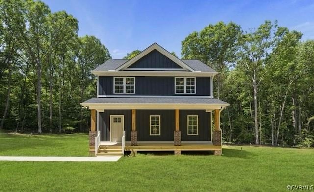 exterior space with covered porch and a front yard